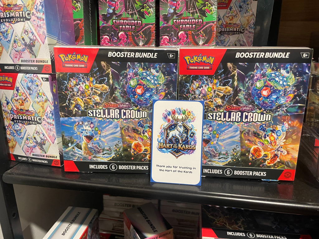 A retail shelf display featuring multiple Pokémon TCG booster bundles, including Stellar Crown and Pramatic, with a central Harry's Cards thank-you card in front.